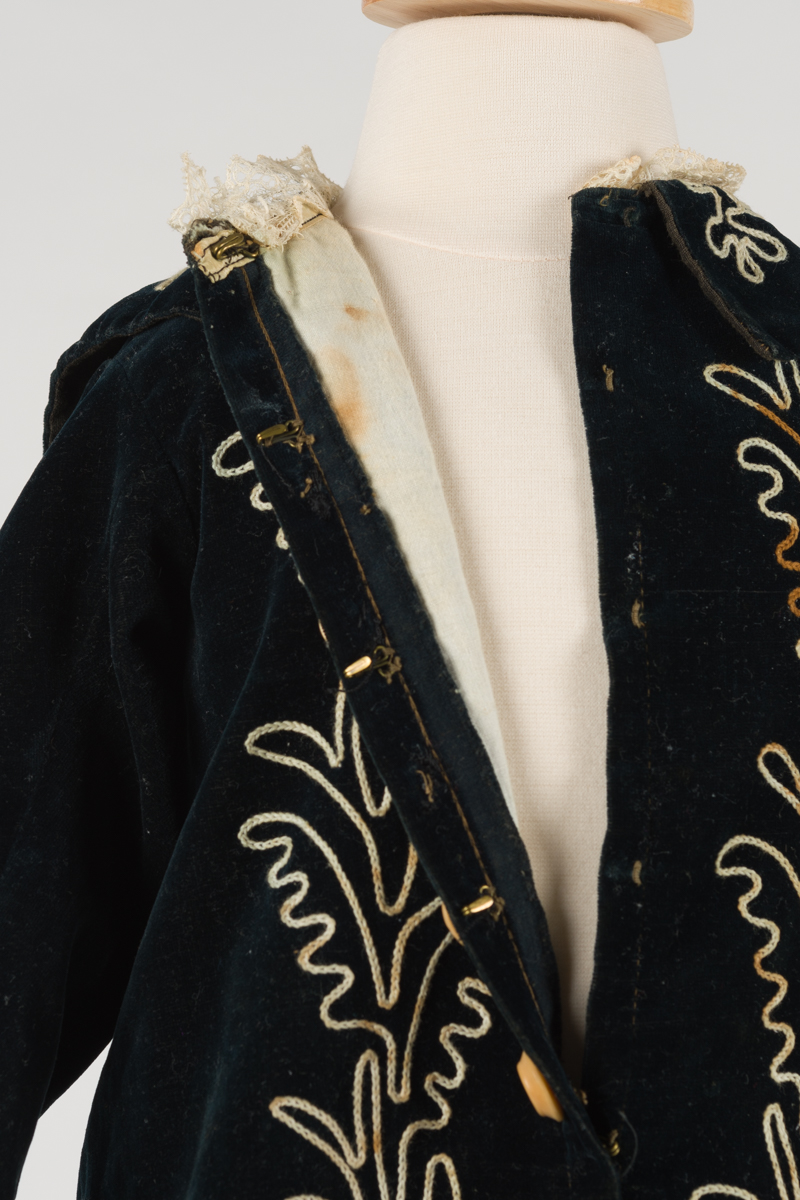 detail of coat unbuttoned, it has an aged white lining