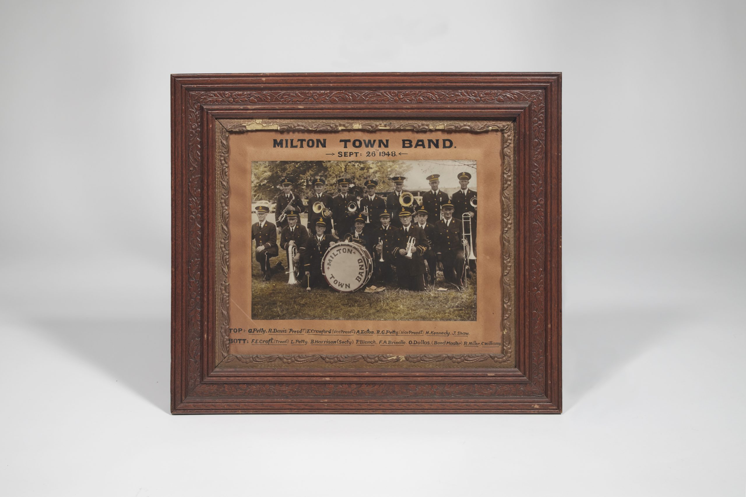 Framed photograph of the Milton Town Band in 1948, including a bass drum front and centre
