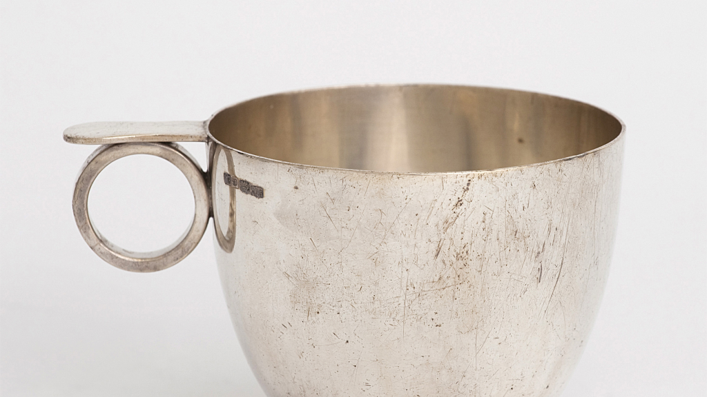 Slightly oxidised, silver cup with a small circle handle