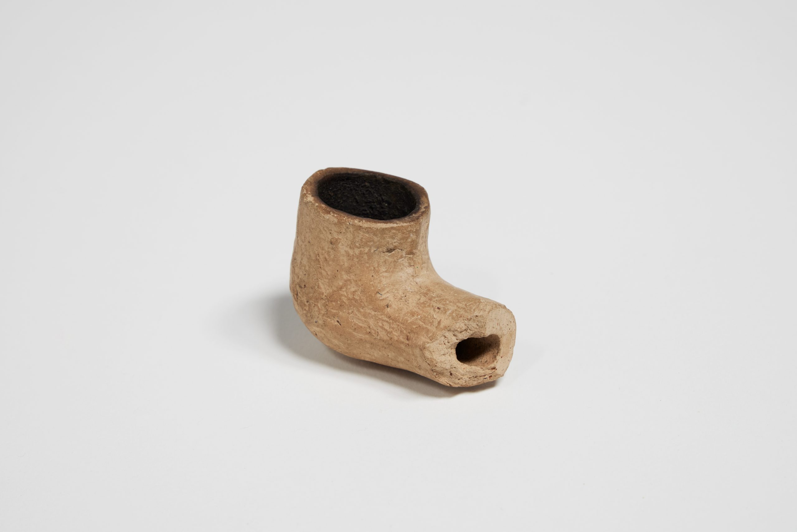 handmade clay pipe with the stem missing
