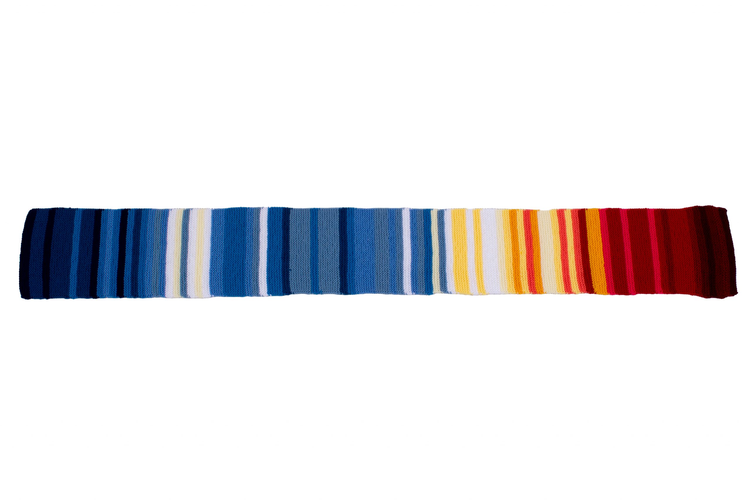 Striped scarf which looks like a spectrum, with shades of blue and white slowly moving towards varying shades of red.