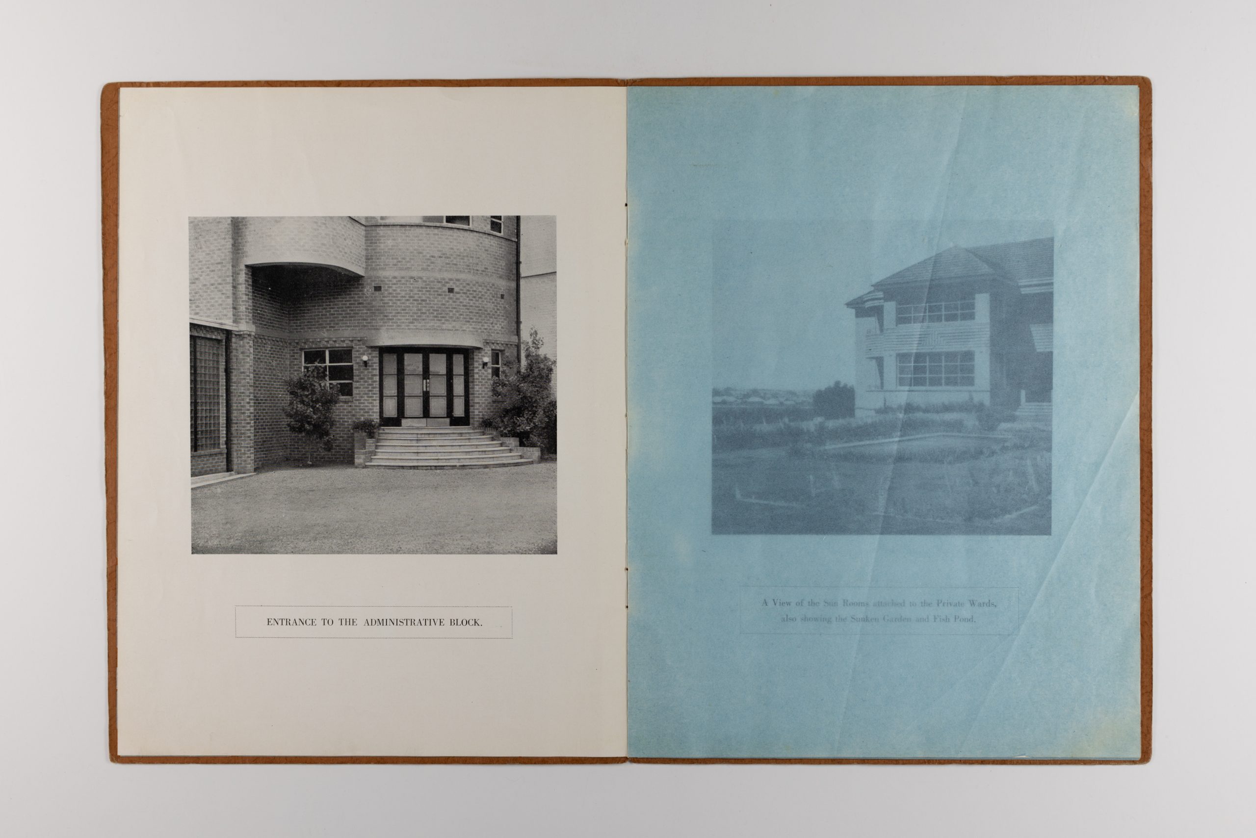 open pages of booklet, the left page has an image of the entrance to the administrative block, the right page is a semi-transparent blue page