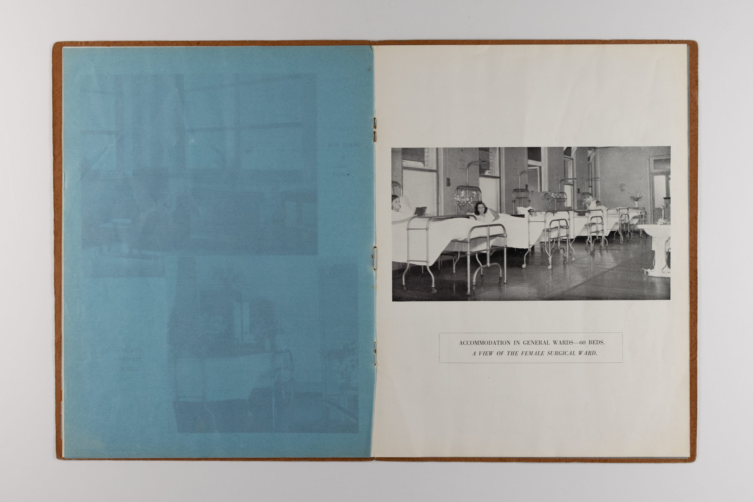 open pages of booklet, the left page is a semi-transparent blue page, the right page is an image of patients in beds within the Female Surgical Ward