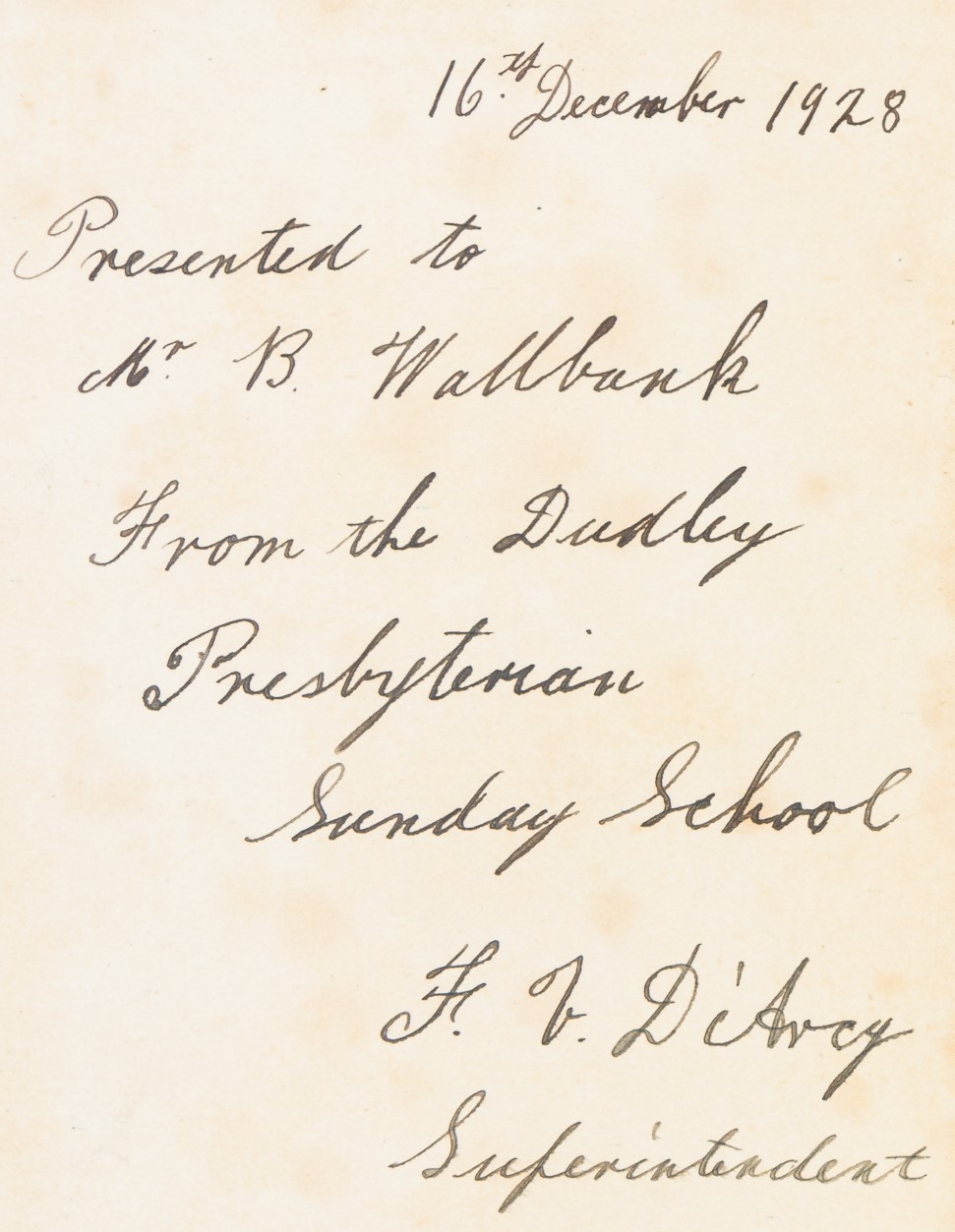 Handwritten cursive which reads: "16th December 1928. Presented to Mr. B. Wallbank From the Dudley Presbyterian Secondary School. F.V. D'Arcy, Superintendent."