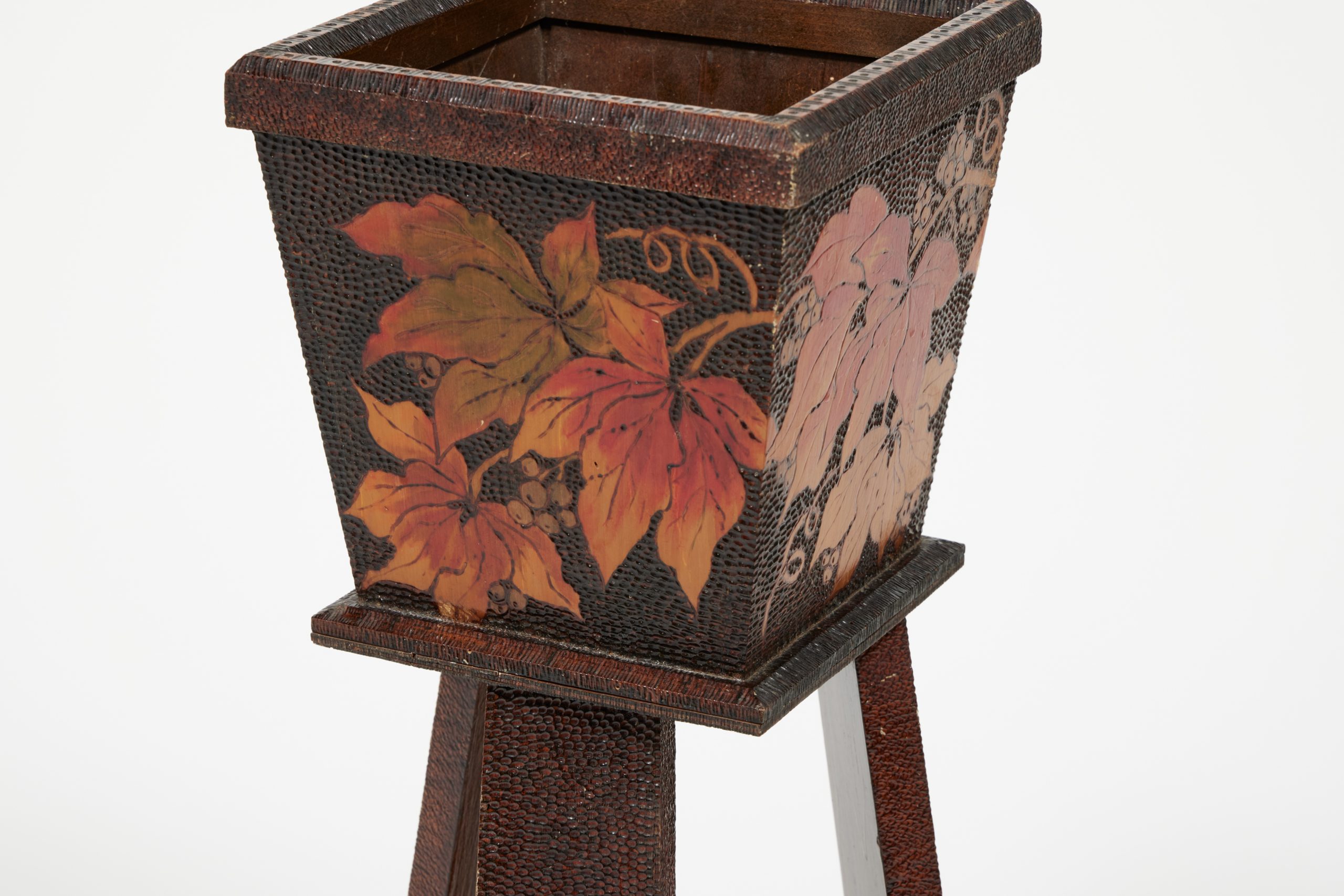 Holder of plant stand with Virginia creeper vines burned into the wood