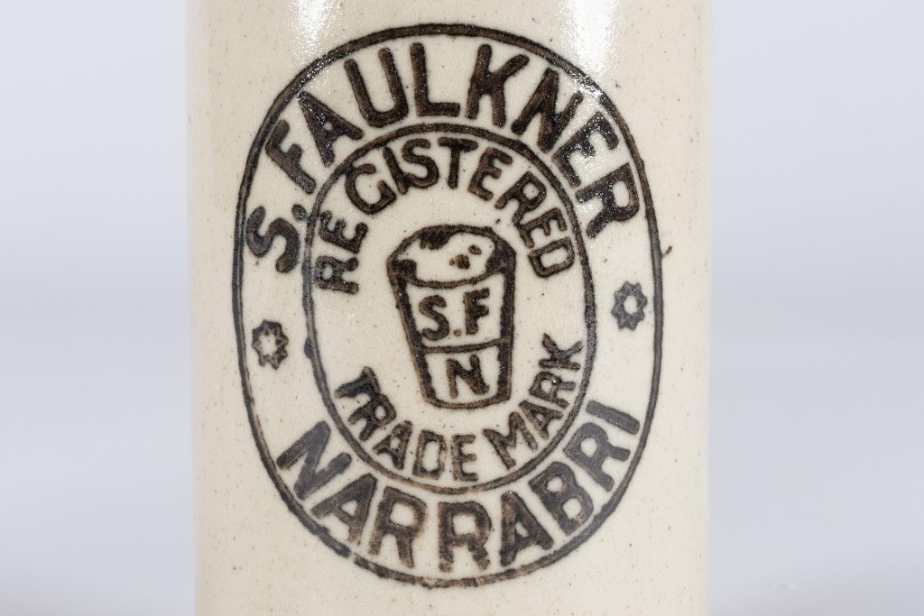 ceramic bottle label which reads 'S. FAULKNER - NARRABRI / REGISTED TRADEMARK / S.F N'
